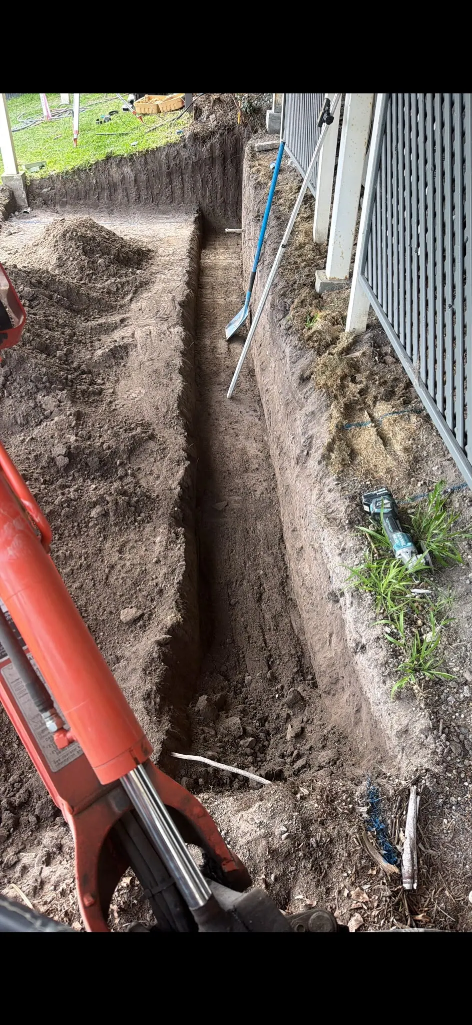 Narrow footing trench beside a house