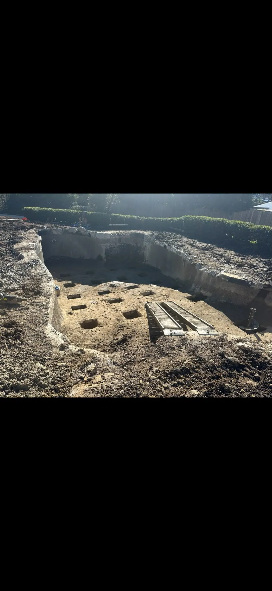 Excavated site with drilled footing holes