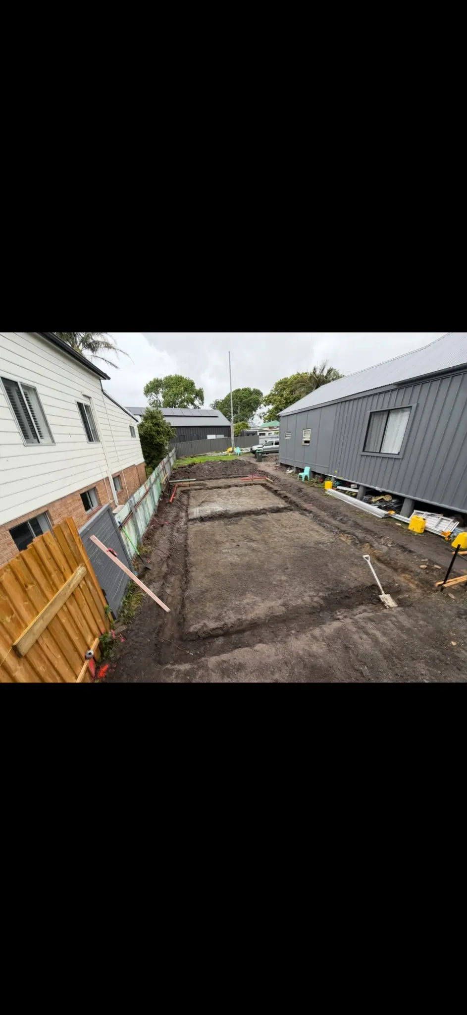 Foundation excavation beside a home