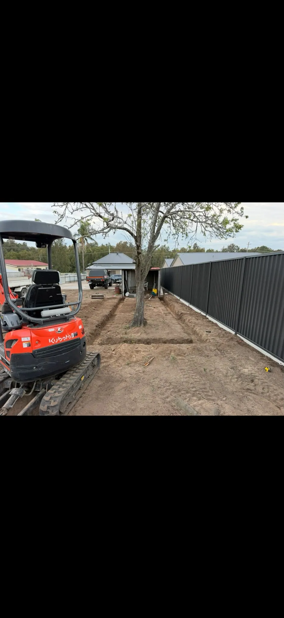 Compact excavator on a backyard dig