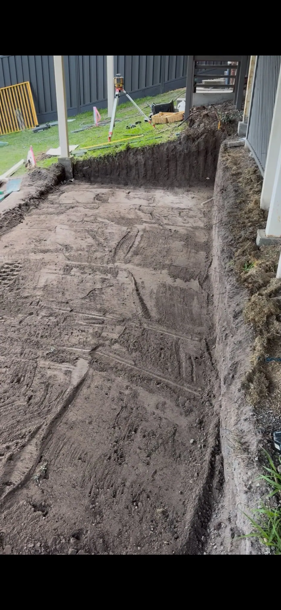 Excavated pad beside an existing house