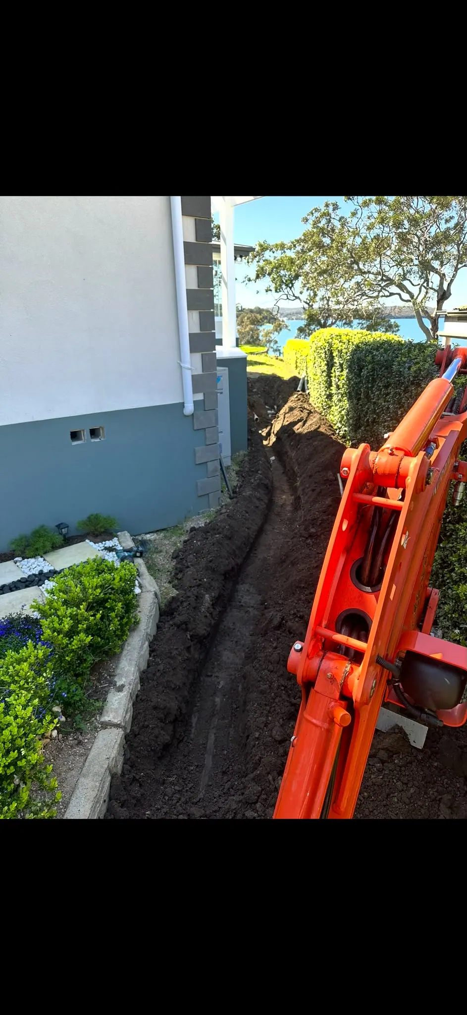 Side access trench alongside a home