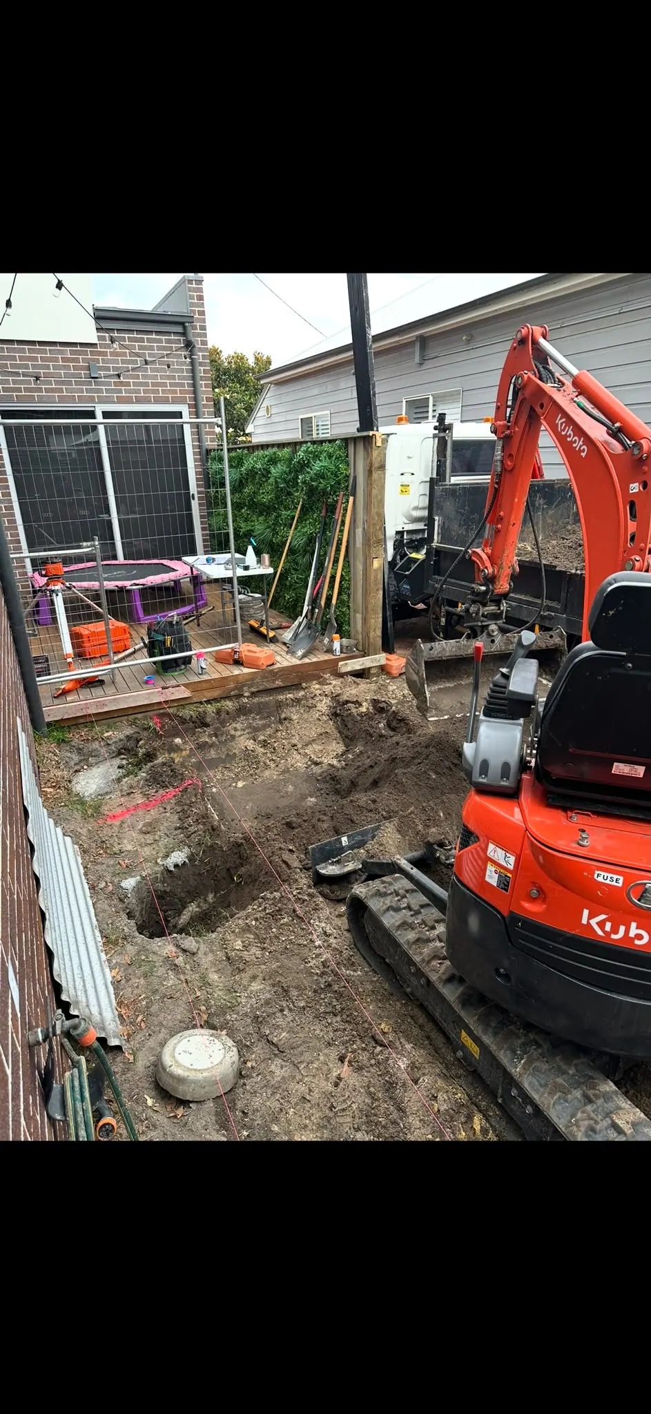 Footing excavation in a compact yard